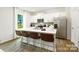 Bright kitchen with stainless steel appliances, a large island with seating, and ample counter space at 5232 Reedy Ridge Rd, Charlotte, NC 28215