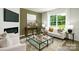 Bright living room with fireplace, TV, couch and large window with view at 5232 Reedy Ridge Rd, Charlotte, NC 28215