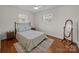 Inviting bedroom featuring wood floors, ceiling fan and natural light at 5301 Baker Dr, Charlotte, NC 28210