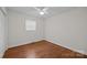 Cozy bedroom with hardwood floors, ceiling fan, and ample natural light at 5301 Baker Dr, Charlotte, NC 28210