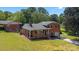 Inviting brick home with covered porch and a well-maintained front lawn at 5301 Baker Dr, Charlotte, NC 28210