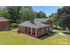 Inviting brick home with covered porch and a well-maintained front lawn at 5301 Baker Dr, Charlotte, NC 28210