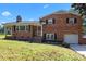 Beautiful red brick home with a manicured lawn, garage, and covered porch, perfect for enjoying the outdoors at 5301 Baker Dr, Charlotte, NC 28210