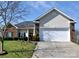 Charming single-story home featuring a two-car garage, brick accents, well-maintained lawn, and concrete driveway at 5927 Patricia Ryan Dr, Charlotte, NC 28216