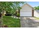 Lovely home featuring a manicured lawn, a brick-accented facade, and a convenient two-car garage at 5927 Patricia Ryan Dr, Charlotte, NC 28216