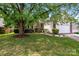 Charming home featuring a well-manicured front yard, lush landscaping, and a welcoming two-car garage at 5927 Patricia Ryan Dr, Charlotte, NC 28216