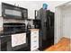 Classic kitchen featuring black appliances and white cabinets at 5927 Patricia Ryan Dr, Charlotte, NC 28216