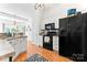 Cozy kitchen with black appliances, white cabinets, and wood flooring at 5927 Patricia Ryan Dr, Charlotte, NC 28216