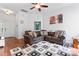 Open-concept living room with hardwood floors, a leather sectional sofa, and a modern patterned rug at 5927 Patricia Ryan Dr, Charlotte, NC 28216