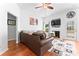 Comfortable living room featuring a leather couch, fireplace with TV, and access to the backyard at 5927 Patricia Ryan Dr, Charlotte, NC 28216