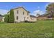 Spacious backyard featuring a wooden deck, lush green lawn, and mature trees, perfect for outdoor enjoyment at 63 Frost Ln, Taylorsville, NC 28681