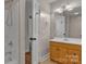A bathroom features a shower and a vanity, with a glimpse into another room at 63 Frost Ln, Taylorsville, NC 28681