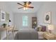 Cozy bedroom featuring neutral walls, a ceiling fan and carpet, and a desk near the window at 63 Frost Ln, Taylorsville, NC 28681