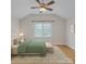 A bright bedroom featuring a large window, wood floors, and neutral decor at 63 Frost Ln, Taylorsville, NC 28681