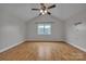 An empty room with wood floors, a window, and a ceiling fan offering a bright space at 63 Frost Ln, Taylorsville, NC 28681