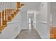 Bright foyer featuring tile flooring, wainscoting, and a staircase with wood treads at 63 Frost Ln, Taylorsville, NC 28681