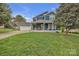 Charming two-story blue home featuring a spacious front yard and an attached garage with a basketball hoop at 63 Frost Ln, Taylorsville, NC 28681
