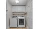 Functional laundry room with modern washer and dryer, built-in cabinets, and neutral tones at 63 Frost Ln, Taylorsville, NC 28681