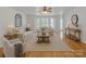 Bright living room with hardwood floors, ceiling fan, and plenty of natural light from large windows at 63 Frost Ln, Taylorsville, NC 28681
