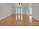 Spacious living room featuring hardwood floors and large windows for abundant natural light at 63 Frost Ln, Taylorsville, NC 28681