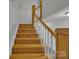 A wooden staircase with white spindles adds a touch of elegance to this home at 63 Frost Ln, Taylorsville, NC 28681