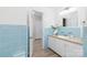 Quaint bathroom with blue tile, vanity, and modern fixtures at 6325 Elmwood Cir, Charlotte, NC 28214
