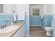 Charming blue tiled bathroom with modern sink, toilet, and towels at 6325 Elmwood Cir, Charlotte, NC 28214
