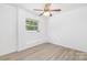 Well-lit bedroom with clean white walls, a window, and wood-look floors at 6325 Elmwood Cir, Charlotte, NC 28214