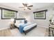 Beautifully decorated bedroom with gray walls, two windows, and a ceiling fan at 6325 Elmwood Cir, Charlotte, NC 28214