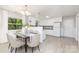 Open dining area adjacent to the kitchen, featuring natural light, stylish table set, and view to kitchen at 6325 Elmwood Cir, Charlotte, NC 28214