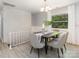 Dining room featuring modern decor, a stylish light fixture, and a large window providing natural light at 6325 Elmwood Cir, Charlotte, NC 28214
