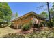 Brick two-story home with a lush green lawn and mature landscaping at 6325 Elmwood Cir, Charlotte, NC 28214