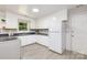 Functional kitchen with classic white cabinetry, modern gray countertops, and natural lighting at 6325 Elmwood Cir, Charlotte, NC 28214