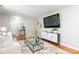 Cozy living room with hardwood floors, a stylish gray sofa, and a contemporary entertainment center for modern living at 6325 Elmwood Cir, Charlotte, NC 28214