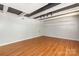 Open living room with exposed ceiling beams and hardwood floors at 6325 Elmwood Cir, Charlotte, NC 28214