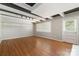 Bright living room with hardwood floors and a white brick fireplace at 6325 Elmwood Cir, Charlotte, NC 28214