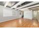 Spacious living room featuring hardwood floors, recessed lighting, and access to stairs at 6325 Elmwood Cir, Charlotte, NC 28214