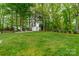 Backyard firepit area featuring landscaping, a tool shed and plentiful greenspace for outdoor activity at 6339 Montpelier Rd, Charlotte, NC 28210