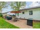 Inviting backyard featuring a charming brick patio, an outdoor grill, and well-maintained green space at 6339 Montpelier Rd, Charlotte, NC 28210