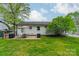 Lush backyard featuring a patio, an outdoor grill, and well-maintained green space with mature shade trees at 6339 Montpelier Rd, Charlotte, NC 28210
