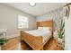 Cozy bedroom with hardwood floors and a decorative accent wall at 6339 Montpelier Rd, Charlotte, NC 28210