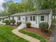 Charming single-story home with freshly painted brick, manicured lawn, and landscaped garden at 6339 Montpelier Rd, Charlotte, NC 28210