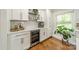 Stylish bar area features custom cabinetry and beverage fridge at 6339 Montpelier Rd, Charlotte, NC 28210