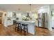 Contemporary kitchen with a spacious island, stainless steel refrigerator, and stylish pendant lights at 6339 Montpelier Rd, Charlotte, NC 28210