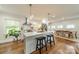 Modern kitchen with a large island, pendant lighting, stainless steel appliances, and hardwood floors at 6339 Montpelier Rd, Charlotte, NC 28210