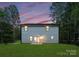 Exterior view of home featuring a spacious backyard and sliding glass doors to the patio at 6524 Robert St, Huntersville, NC 28078