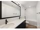 Modern bathroom with double vanity, sleek fixtures, and a shower-tub combo at 6524 Robert St, Huntersville, NC 28078