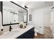Modern bathroom with double vanity, black fixtures, and a walk-in shower with glass doors at 6524 Robert St, Huntersville, NC 28078