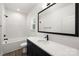 Bathroom with vanity, a mirror, and a tub shower with white tile surround at 6524 Robert St, Huntersville, NC 28078