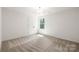 Bright and airy bedroom with a window and double door closet at 6524 Robert St, Huntersville, NC 28078